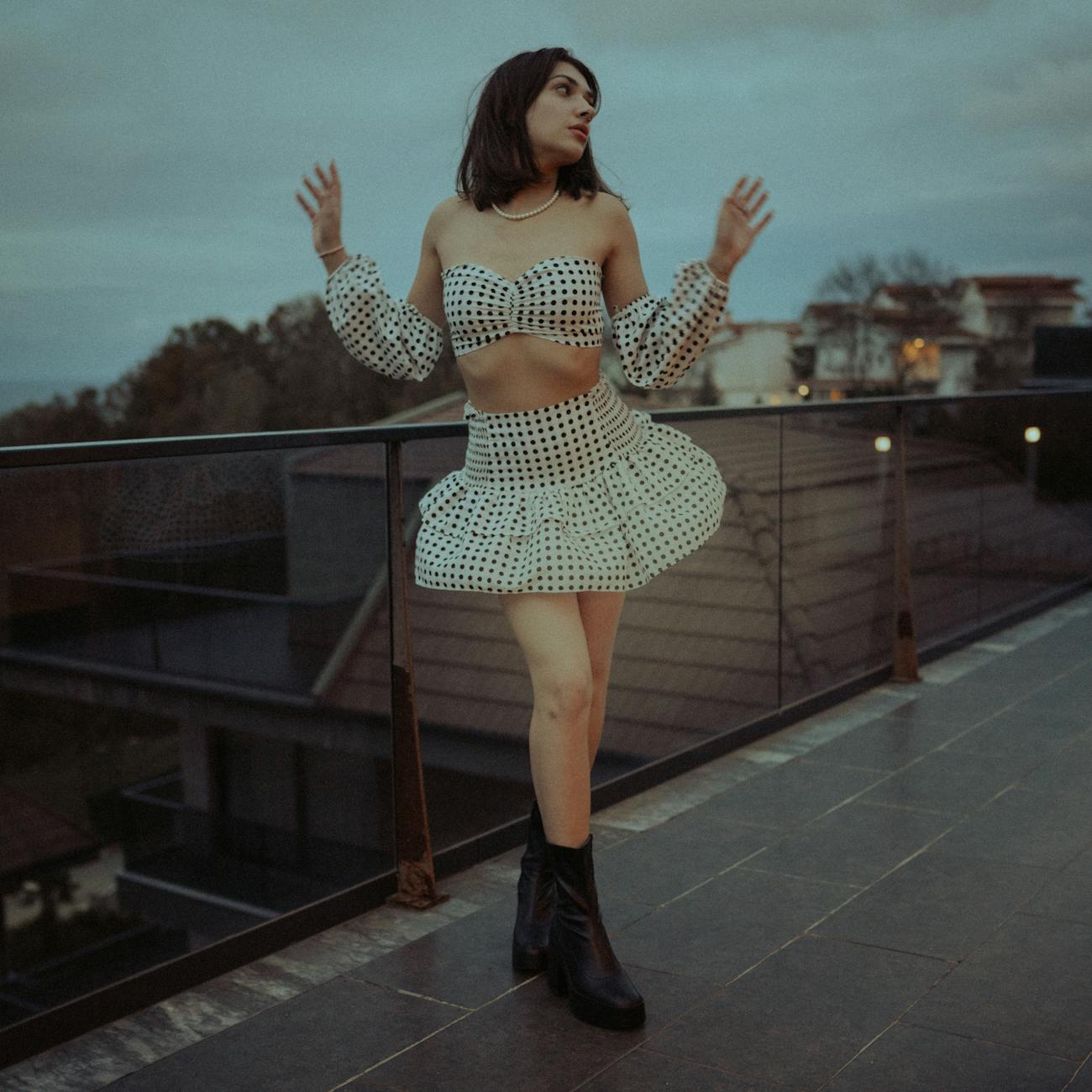 woman wearing a polka dot crop top and skirt